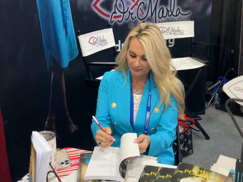 Autographing books at NRB