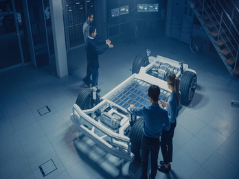 Engineers work on electric vehicle