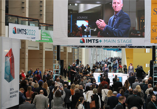 Presentations on the IMTS+ Main Stage at IMTS 2024 include executives from BlueForge Alliance, Google Cloud, Hexagon Manufacturing Intelligence, Microsoft, Manufacturing USA, RFK Racing, Siemens USA, Strategic Submarines, and (shown here) Douglas K. Woods, president of AMT – The Association For Manufacturing Technology.